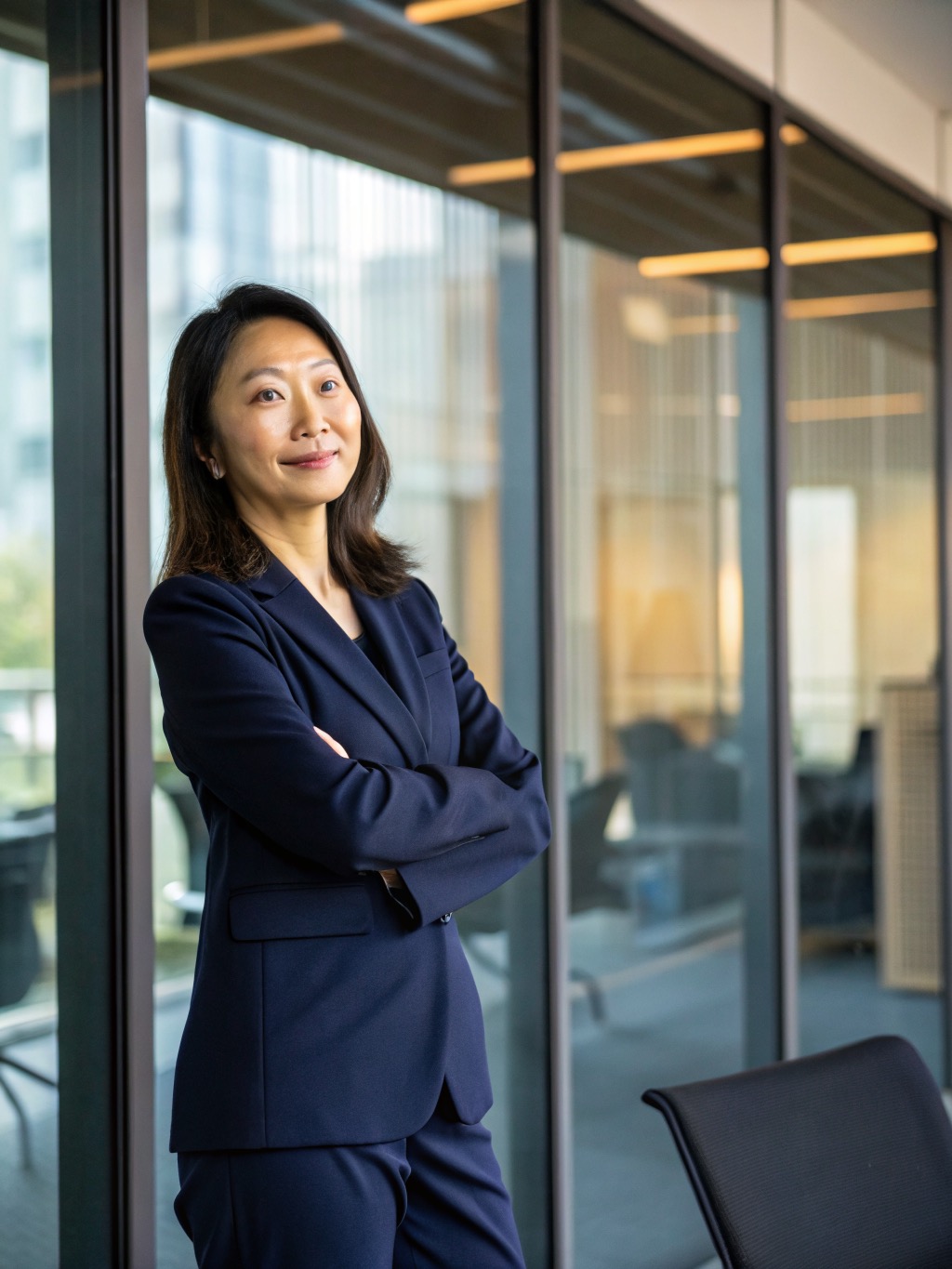 Confident Asian Businesswoman Standing in Modern Corporate Office
